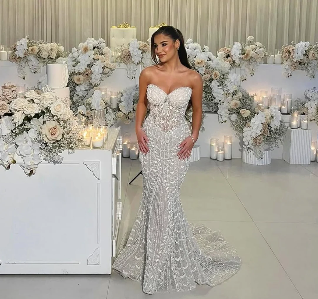 Elegant embellished silver evening gown worn at a formal event